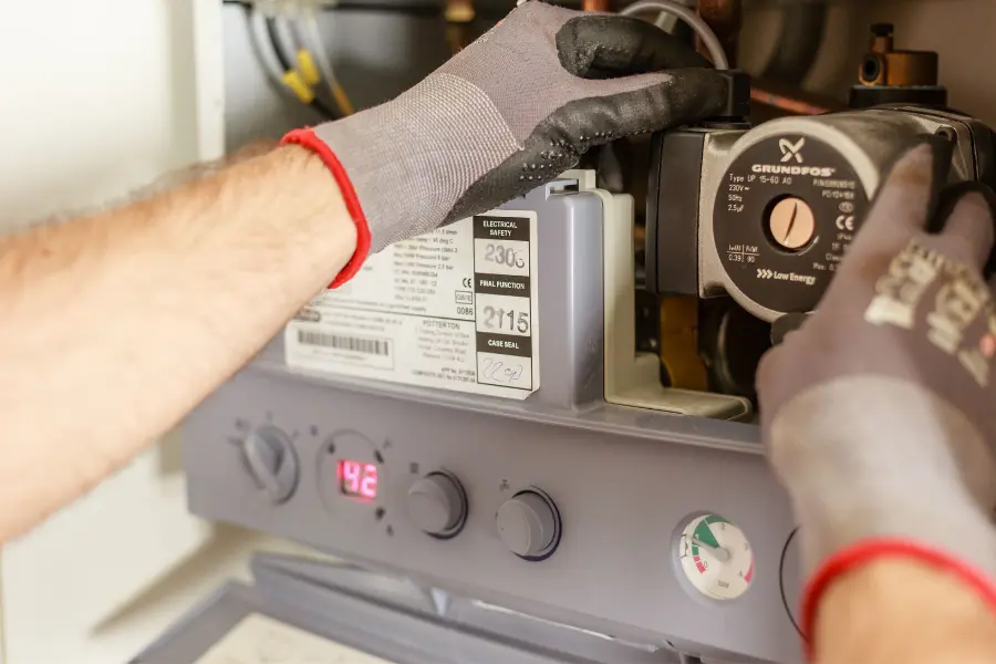 Gas safe engineer servicing a boiler in UK home
