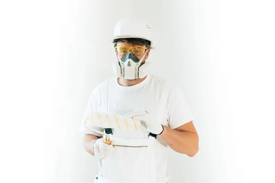 UK painter and decorator painting interior room walls