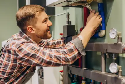UK plumber fixing burst pipes in residential property